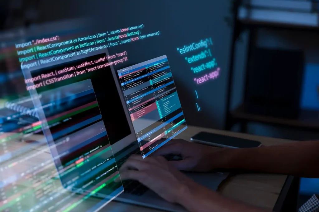Developer coding on multiple computer screens representing IT solutions, software development, cybersecurity, digital transformation, and technology innovation blog content.