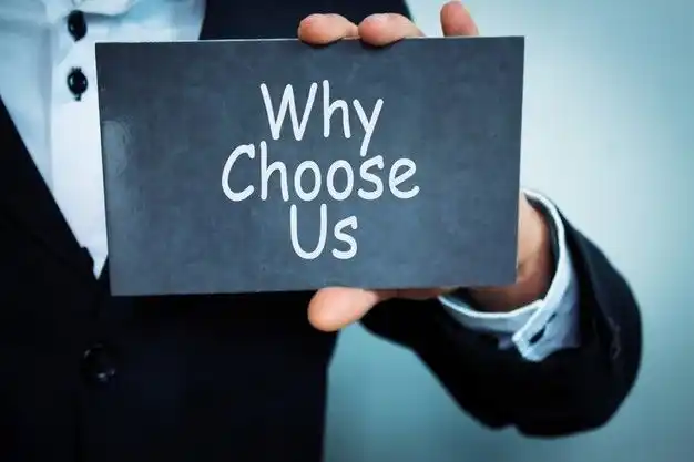 Business professional holding a “Why Choose Us” sign representing trusted UAE accounting, audit, compliance, business setup, support, and IT service solutions.